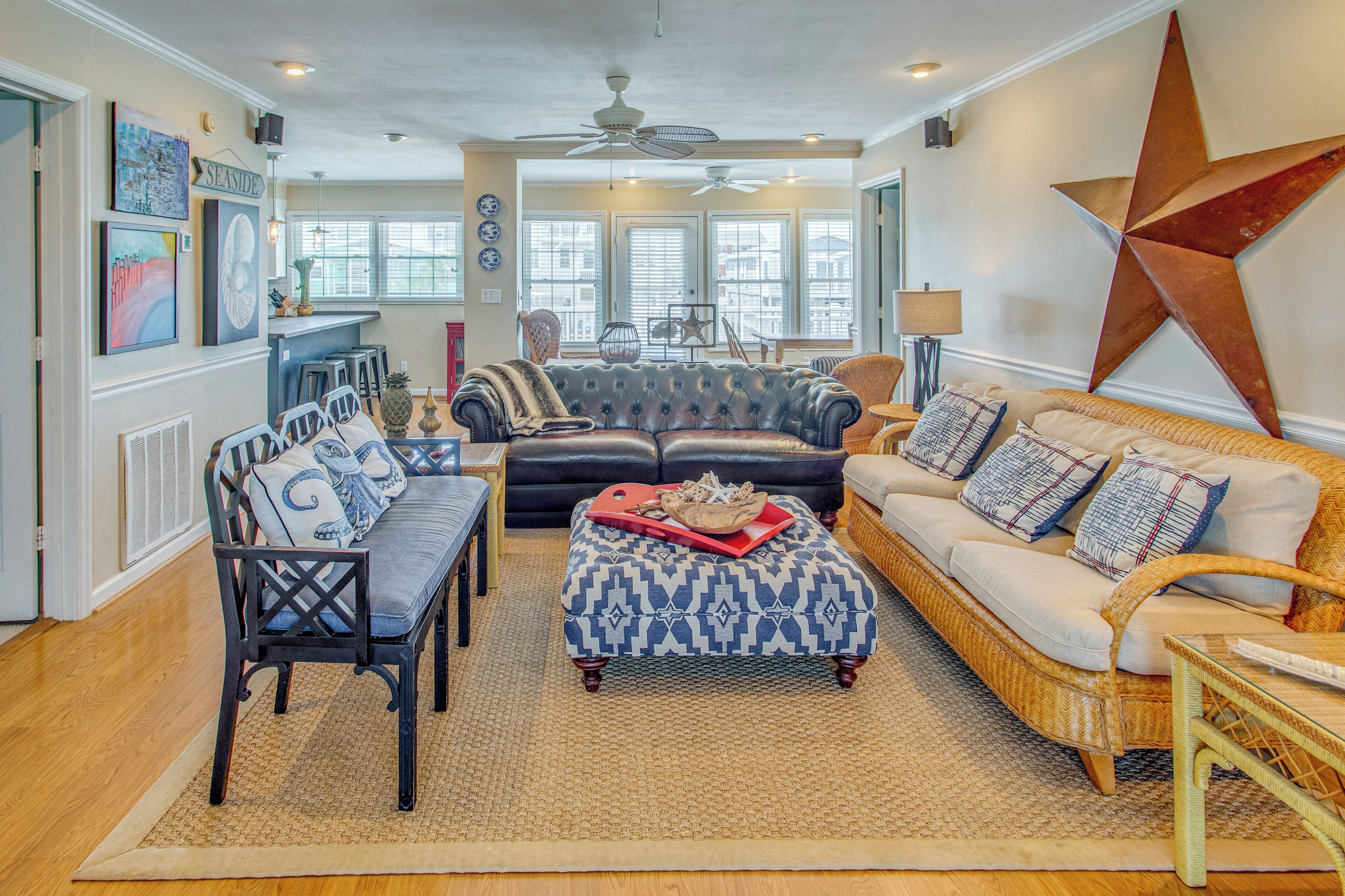 A living room with a sofa, chairs, a coffee table, and a large decorative star on the wall.