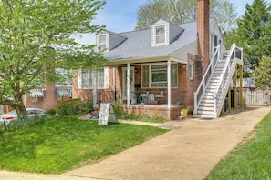 A two-story house with a covered porch, a staircase, and a brick chimney. - Gateway to Downtown Baltimore! Cozy & Private Unit (Baltimore)