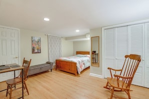 A bedroom with a bed, a desk, two chairs, a sofa, and a wardrobe. - Gateway to Downtown Baltimore! Cozy & Private Unit (Baltimore)