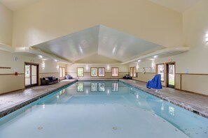 A large indoor swimming pool with tiled walls and a high ceiling. - Whitefish Lake Couples Escape w/ Community Perks! (Whitefish)