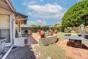 A residential backyard with a patio, outdoor furniture, a tree, and a fence. - On Sun City South Golf Course! Quiet Home w/ Patio (Sun City)