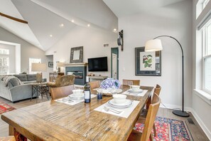 A spacious living room with a dining area, a sofa, a TV, and a large window. - Ada-compliant! 'birch Haven' in Baileys Harbor (Baileys Harbor)
