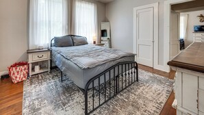 A bedroom with a bed, nightstand, dresser, and a mirror. - Private Deck & Yard: Pet-friendly Noble Getaway (Noble)