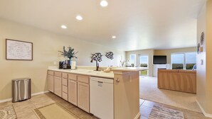 A modern kitchen with a dishwasher, a coffee maker, and a potted plant. - 212 - Life's a beach, take a paws and relax (Westport)