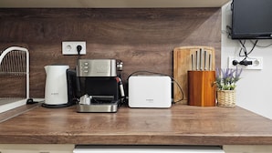 A kitchen with a Bosch coffee maker, a white toaster, and a Liebherr dishwasher. - Stylish&Beutiful
Vitosha Blvd (Sofia)