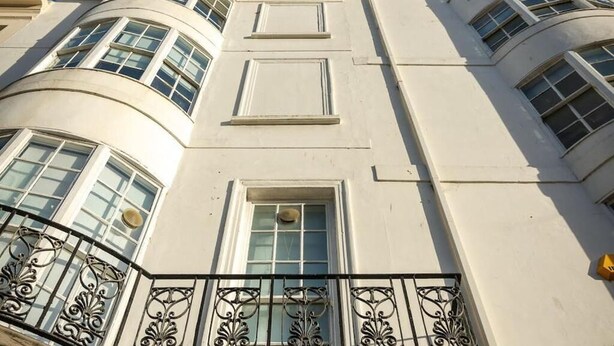 A building with curved balconies, large windows, and a classical architectural style. - Safestay Brighton Royal Pavilion (Brighton)