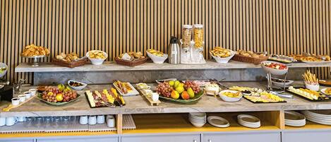 A buffet with various food items and condiments.