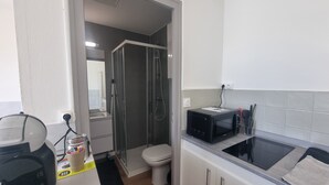 Una kitchenette compacta con microondas, tostadora y pileta.