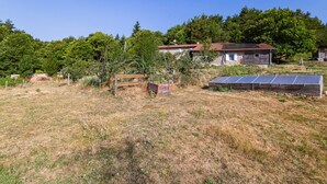 A rural property with a stone house, a wooden fence, and solar panels. - Bed and Breakfast 'Framboise' with Shared Terrace, Shared Garden and Wi-Fi (Belsentes)