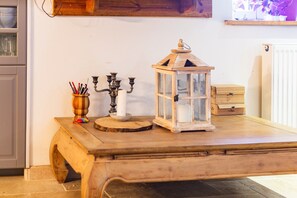 A wooden table with a white lantern and a candle holder. - Bed and Breakfast 'Myrtille' with Shared Terrace, Shared Garden and Wi-Fi (Belsentes)