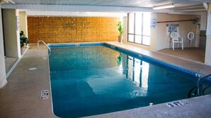 An indoor swimming pool with a wooden wall, a lifeguard chair, and a sign stating 'NO LIFEGUARD ON DUTY.' - 3br Oceanfront Condo w/ Balcony & Pool – Atalaya Towers (Murrells Inlet)