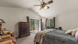 A bedroom with a large bed, a dresser, a chair, and a ceiling fan. - Modern Mountain Chalet w/ Hot Tub, Near the Slopes, Lake & Village (Big Bear Lake)