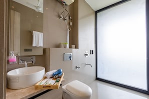 A modern bathroom with a large sink, a toilet, and a shower. - Aurea Avasa (Gurugram)