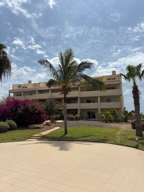 A multi-story building with a tiled walkway leading to the entrance. - Casa Tortuga Sal Apartment 1st Floor With Balcony (Sal)