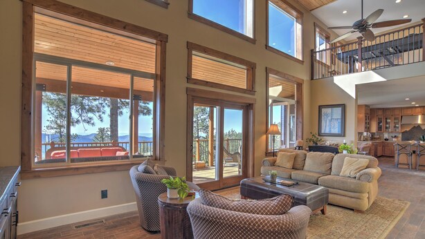 A spacious living area with large windows, a high ceiling, and a view of the outdoors. - Mountain Home on 8 Acres - Amazing Views / Outdoor Spaces - 19 Min to DGO (Durango)