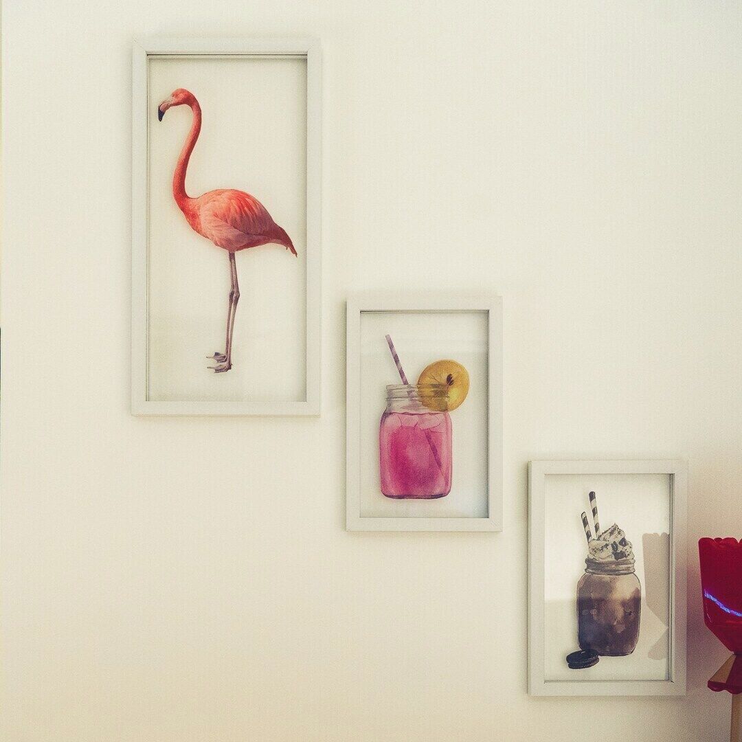 Three framed artworks on a wall.