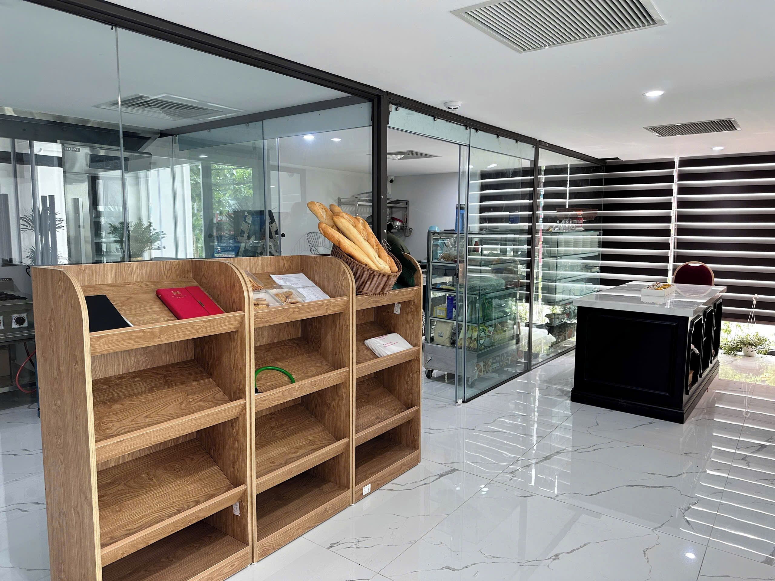 A modern interior with a wooden display unit, glass shelving, and a black cabinet.