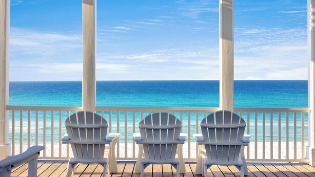A covered deck with three Adirondack chairs facing a beach with clear blue water. - The Poppy House + Seaside, Pet Friendly & Bikes (Santa Rosa Beach)