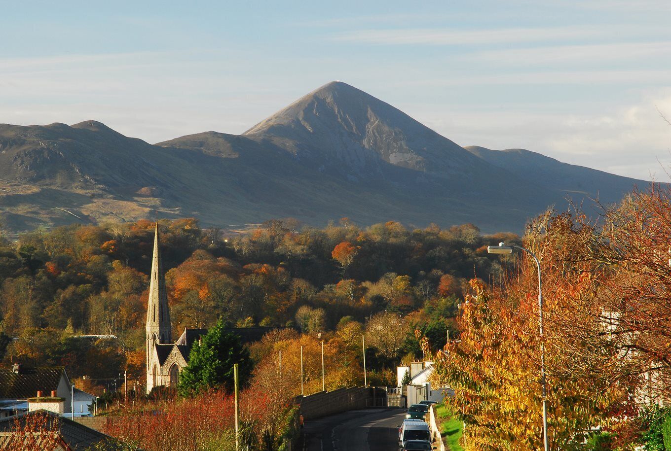 A mountain, a church, and autumn foliage.