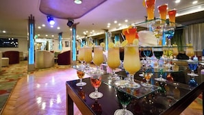 A bar area with a variety of colorful drinks and a modern interior design. - MS Nile Treasure Cruise (Luxor)