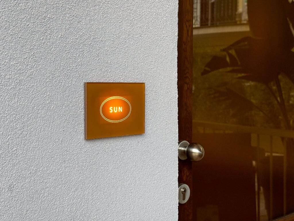 A door with a brass handle and a glass panel.