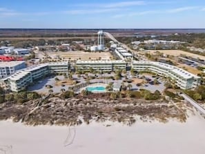 A large hotel with multiple buildings, a swimming pool, and a water tower. - Cozy 1 Bedroom Isle of Palms Beachfront Escape (Isle of Palms)