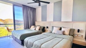 A modern bedroom with a large bed, a ceiling fan, and a view of the outdoors. - Suite Vista A Reserva y Mar Piso Alto En Bello Horizonte (Santa Marta)