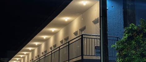A building with a sloped roof, multiple windows, and a balcony with railings.