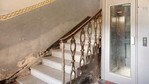 A staircase with ornate metal railings and a glass elevator door. - Bed and Breakfast 'Sentieri' with Wi-Fi and Air Conditioning (Levanto)