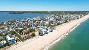 A coastal town with a beachfront, residential buildings, and a marina. - Ocean View from Balconies | Steps to Private Beach (Rehoboth Beach)