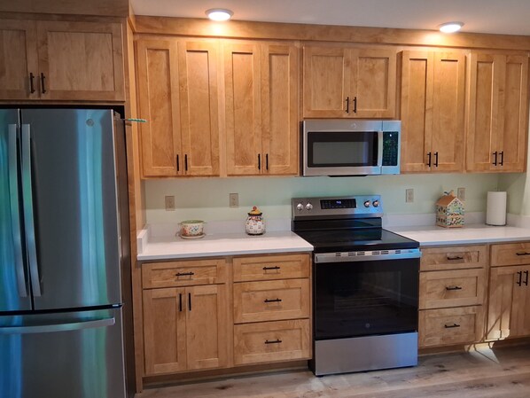 Fridge, microwave, oven, stovetop - Whispering Pines is a lovely 3-bedroom family-friendly home in a wooded setting. (New Pekin)