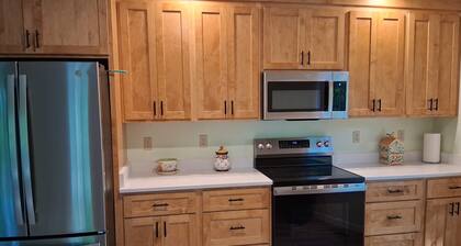 Whispering Pines is a lovely 3-bedroom family-friendly home in a wooded setting.