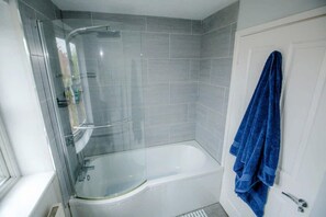 Combined shower/bathtub, deep-soaking bathtub, hair dryer, towels