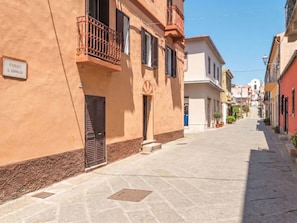 A narrow street with buildings on either side, a sign reading 'CORSO G. CARTALDI,' and a clear blue sky. - Nuraghi by Interhome (Arzachena)