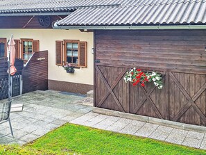 A rustic building with wooden shutters, a metal roof, and a flower box on the wall. - Ferienwohnung Belan by Interhome (Klippitztörl)