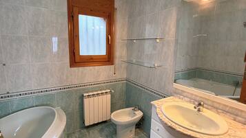 Bidet, towels, soap, toilet paper