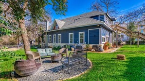 A house with a well-maintained lawn, outdoor seating, and a staircase leading to the entrance. - Casa Azul. Ideal for groups of 8+. 5 bdr / 4 bath (San Antonio)