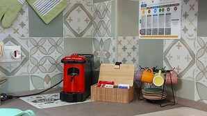 A kitchen with a coffee machine, a wooden box, and a rack with mugs. - LOFT HISTORICAL CENTER CATANIA WITH PRIVATE COURTYARD (Catania)
