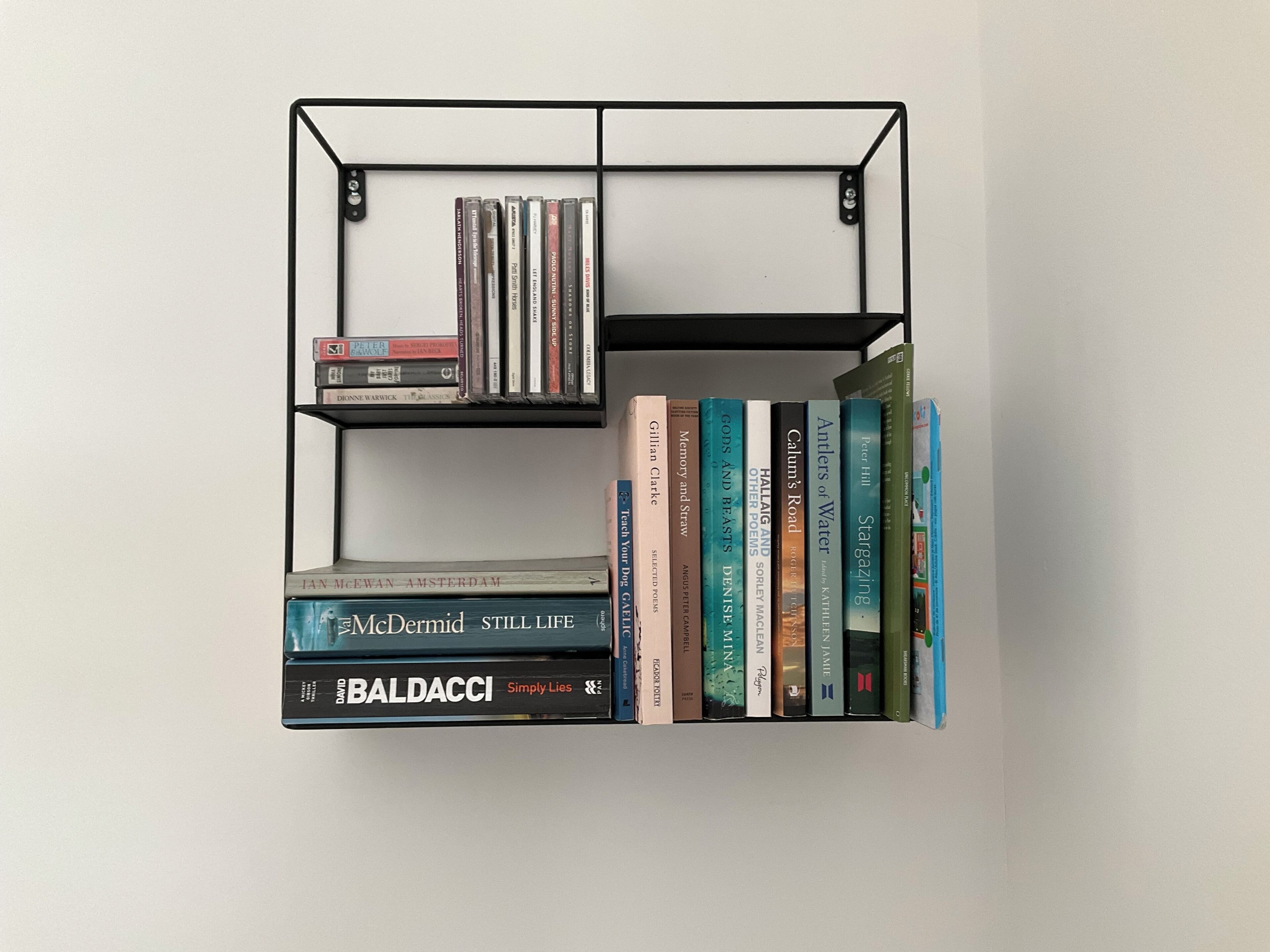 A bookshelf with books and DVDs.
