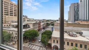 A cityscape with buildings, a street, and a clear sky. - Lively 2 BR Apt Downtown ATX (Austin)