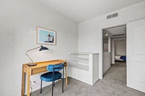 A bedroom with a desk, chair, and a bed. - Lively 2 BR Apt Downtown ATX (Austin)