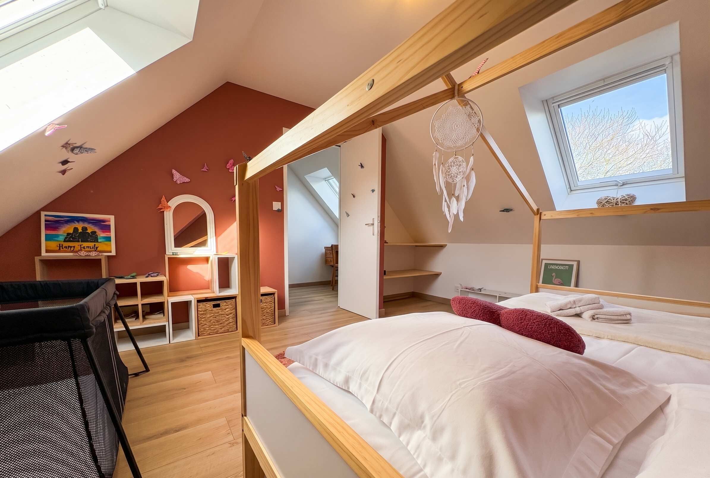 A bedroom with a skylight, bunk beds, a dreamcatcher, and a view of the outdoors.