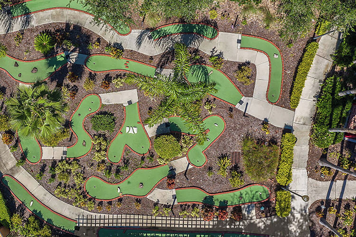 An aerial view of a golf course with multiple green areas and pathways.