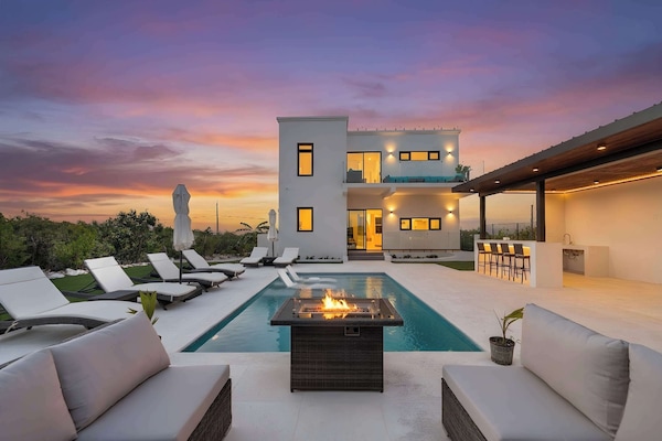 Magic happens at twilight around the outdoor fire pit and pool.