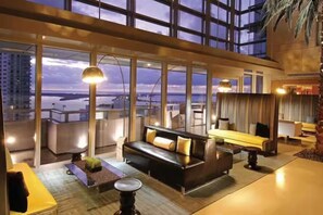A modern hotel room with a large window, a sofa, a coffee table, and a view of the cityscape. - ★@ EXCLUSIVE Large Luxury Water View FREE Parking★ (Miami)
