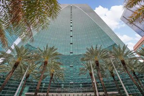 A tall, modern skyscraper with a glass facade, surrounded by palm trees. - ★@ EXCLUSIVE Large Luxury Water View FREE Parking★ (Miami)