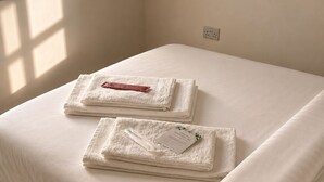 A neatly made bed with folded white towels and slippers on the floor. - Stylish 2-Bed Apt 
| 10 Mins to Oxford Universities/city | Free private parking (Oxford)