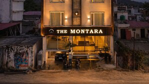 A hotel named 'The Montara' with a vertical sign, multiple windows, and a visible entrance.