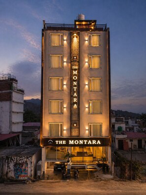 A hotel named 'The Montara' with a vertical sign, multiple windows, and a visible entrance. - Hotel Montarara Rishikesh (Rishikesh)