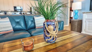 A wooden coffee table with a decorative vase and a coaster. - Blue Pearl Walk to Beach Sleeps 9 New Golf Cart Option (Bolivar Peninsula)